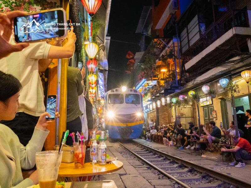 Enjoying coffee and capturing the moment at Train Street Hanoi